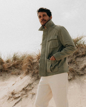 fit model with his hands in his pockets wearing The Surplus Jacket in Field Olive Reverse Sateen, Outerwear by Taylor Stitch