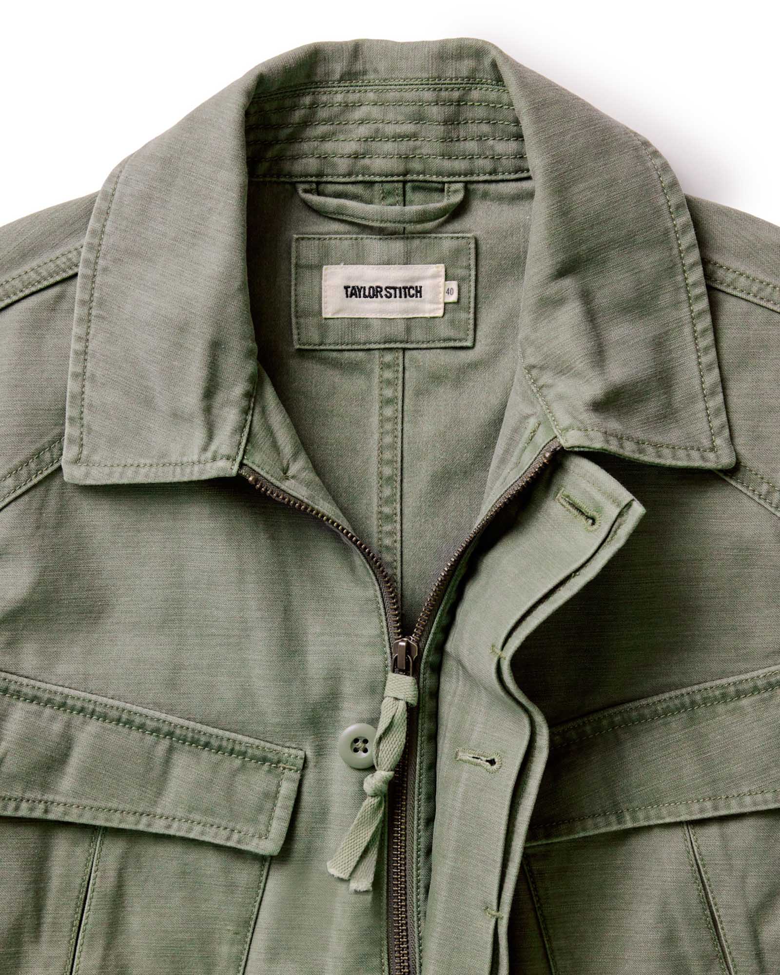 material shot of the collar and zipper front on The Surplus Jacket in Field Olive Reverse Sateen, Outerwear by Taylor Stitch