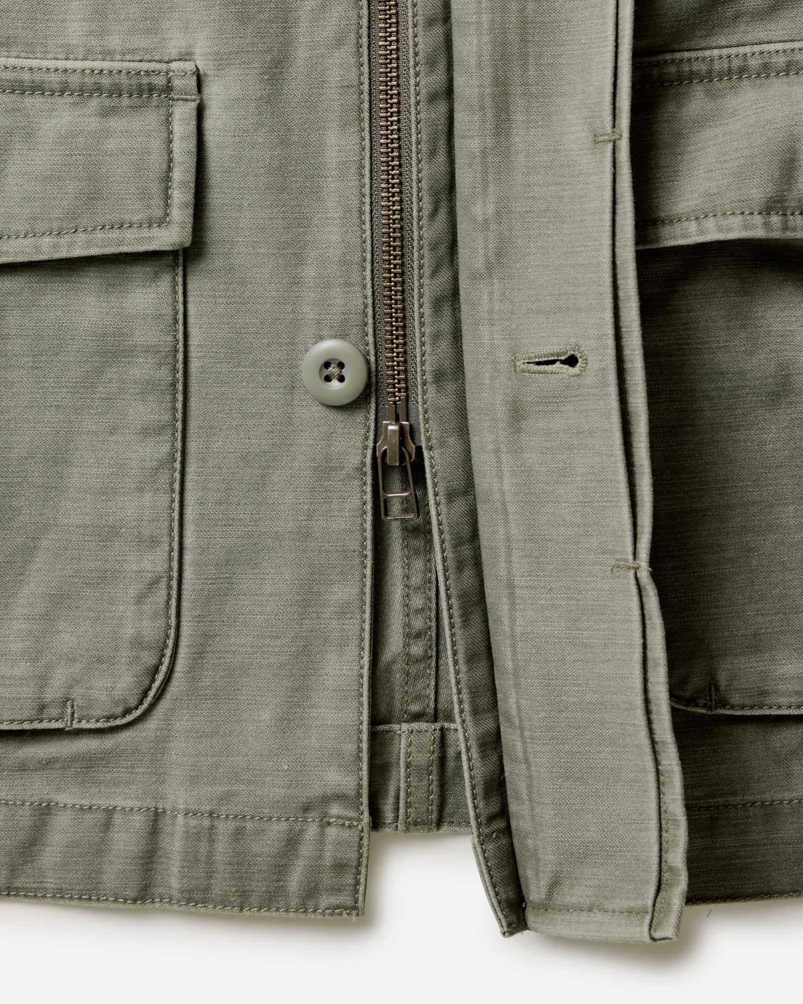 editorial image of the zipper on The Surplus Jacket in Field Olive Reverse Sateen, Outerwear by Taylor Stitch