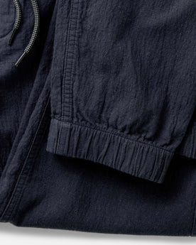 material shot of the cuffs on The Apres Pant in Coal Double Cloth, Bottoms by Taylor Stitch