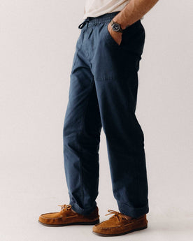 fit model with his hands in his pockets wearing The Breakwater Pant in Dark Navy Ripstop, Bottoms by Taylor Stitch