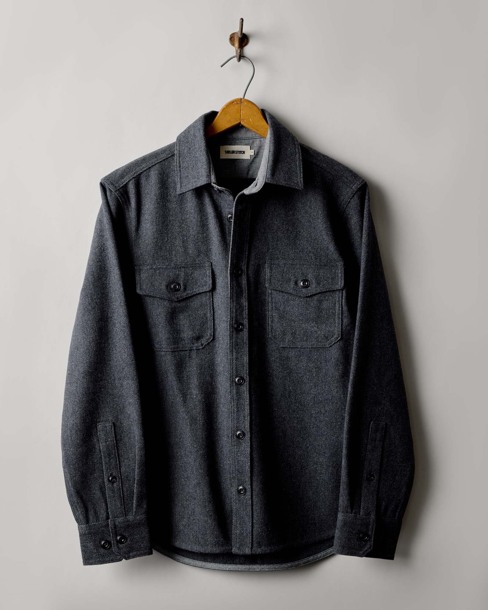 editorial image of The CPO Shirt in Heather Slate Twill hanging, Wovens by Taylor Stitch