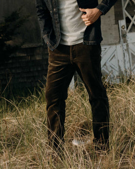 fit model posing in The Carnegie Pant in Fatigue Olive Corduroy, Bottoms by Taylor Stitch