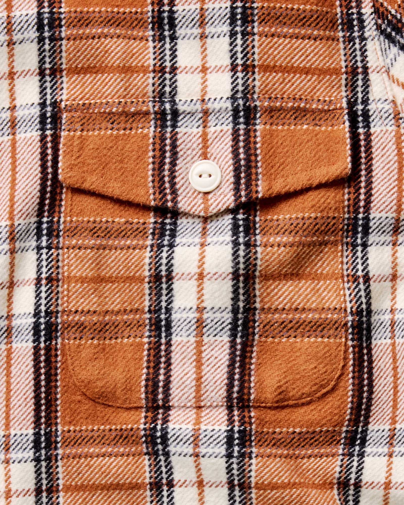 material shot of the pocket with the button on The Crater Shirt in Brick Plaid, Wovens by Taylor Stitch