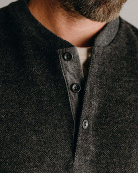 fit model showing off the buttons on The Evans Henley in Charcoal Birdseye Wool, Knits by Taylor Stitch