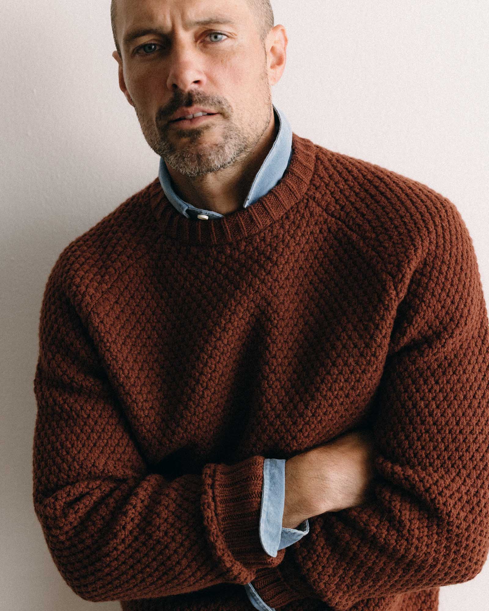 fit model with his arms crossed wearing The Fisherman Sweater in Heather Brick Merino, Knits by Taylor Stitch
