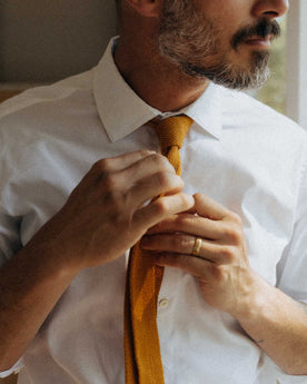 fit model fixing a tie wearing The Hyde Shirt in White Pinpoint Oxford, Wovens by Taylor Stitch