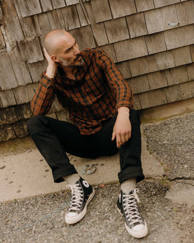 fit model sitting wearing The Jack in Autumn Pine Plaid Flannel, Wovens by Taylor Stitch