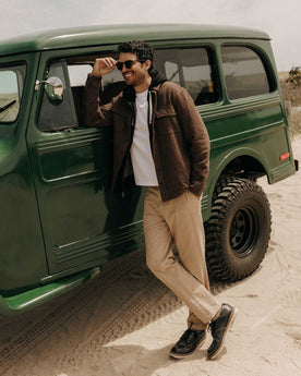 fit model leaning against a car wearing The Ledge Shirt in Black Coffee Linen Tweed, Wovens by Taylor Stitch