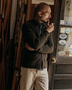 fit model posing in The Mariner Cardigan in Heather Loden Slub, Knits by Taylor Stitch