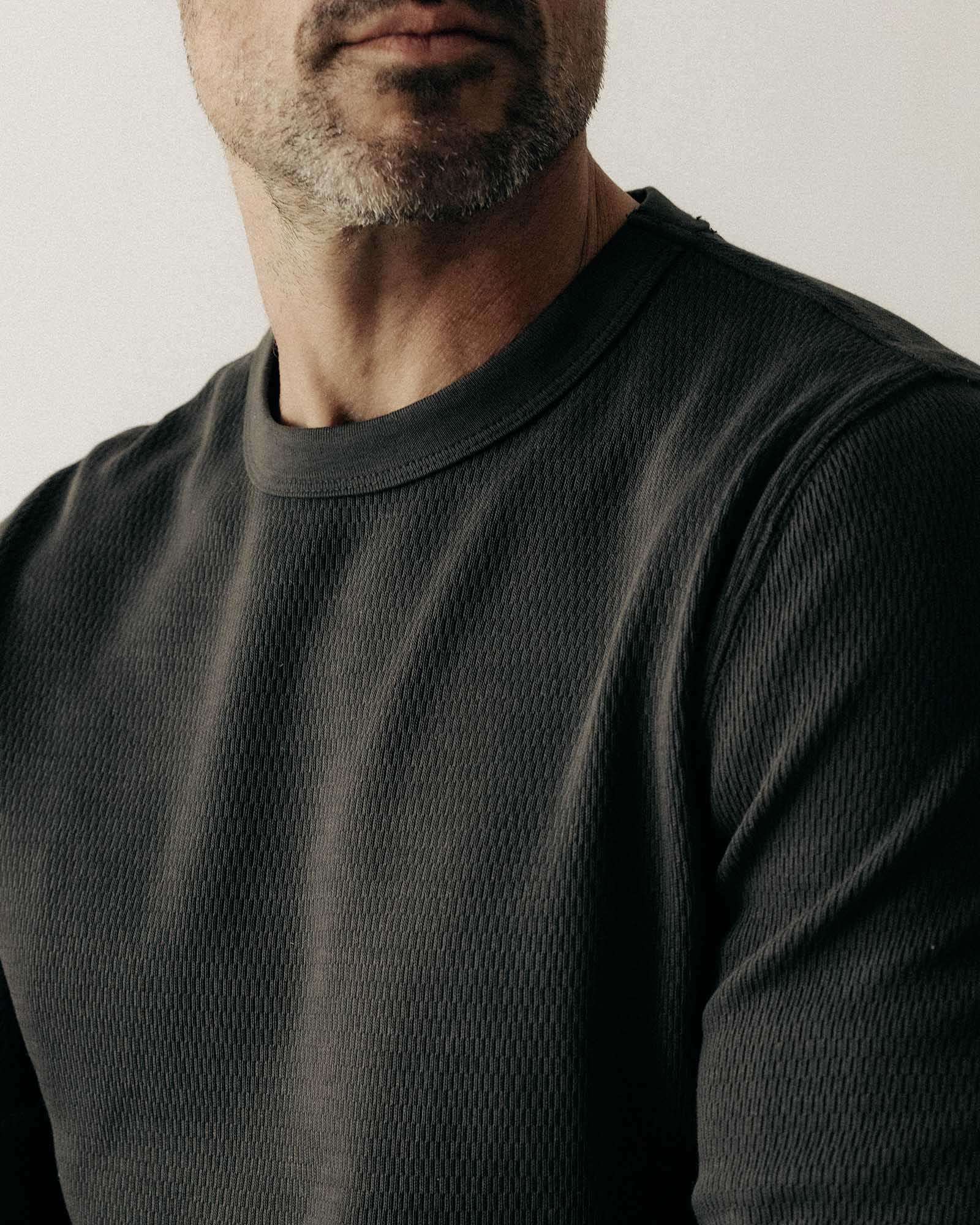 fit model showing off the sleeve on The Organic Cotton Crew in Faded Black Waffle, Knits by Taylor Stitch