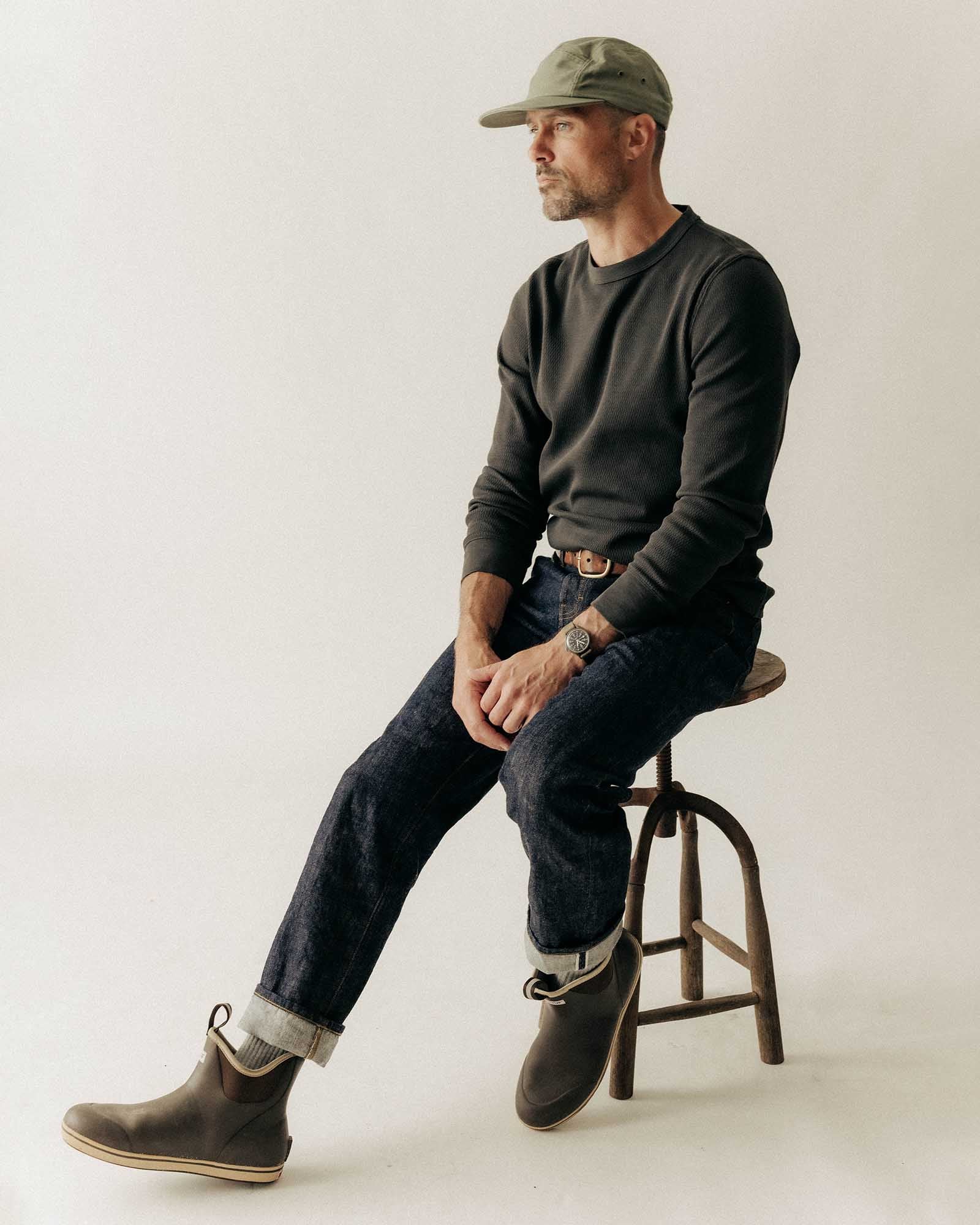 fit model sitting wearing The Organic Cotton Crew in Faded Black Waffle, Knits by Taylor Stitch