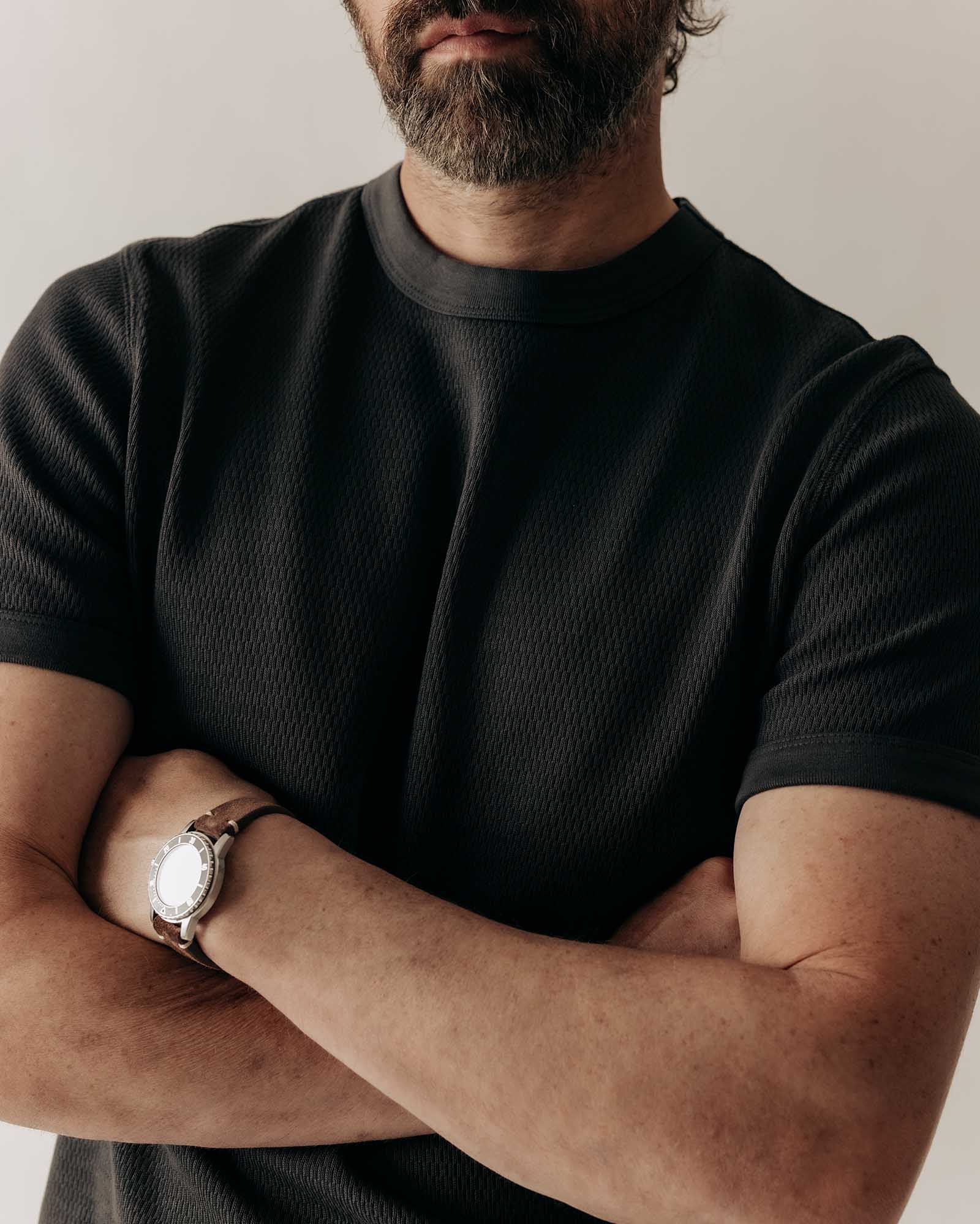 fit model in The Organic Cotton Short Sleeve Crew in Faded Black Waffle, Knits by Taylor Stitch