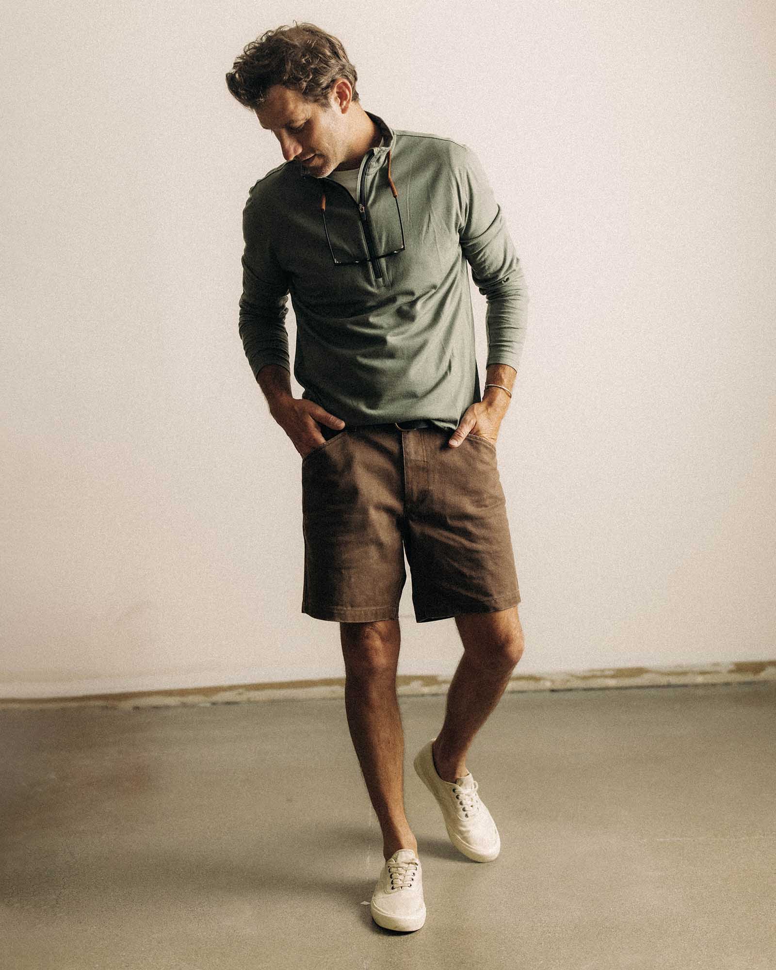 fit model posing in The Ridgeline Merino Half Zip in Field Olive, Knits by Taylor Stitch