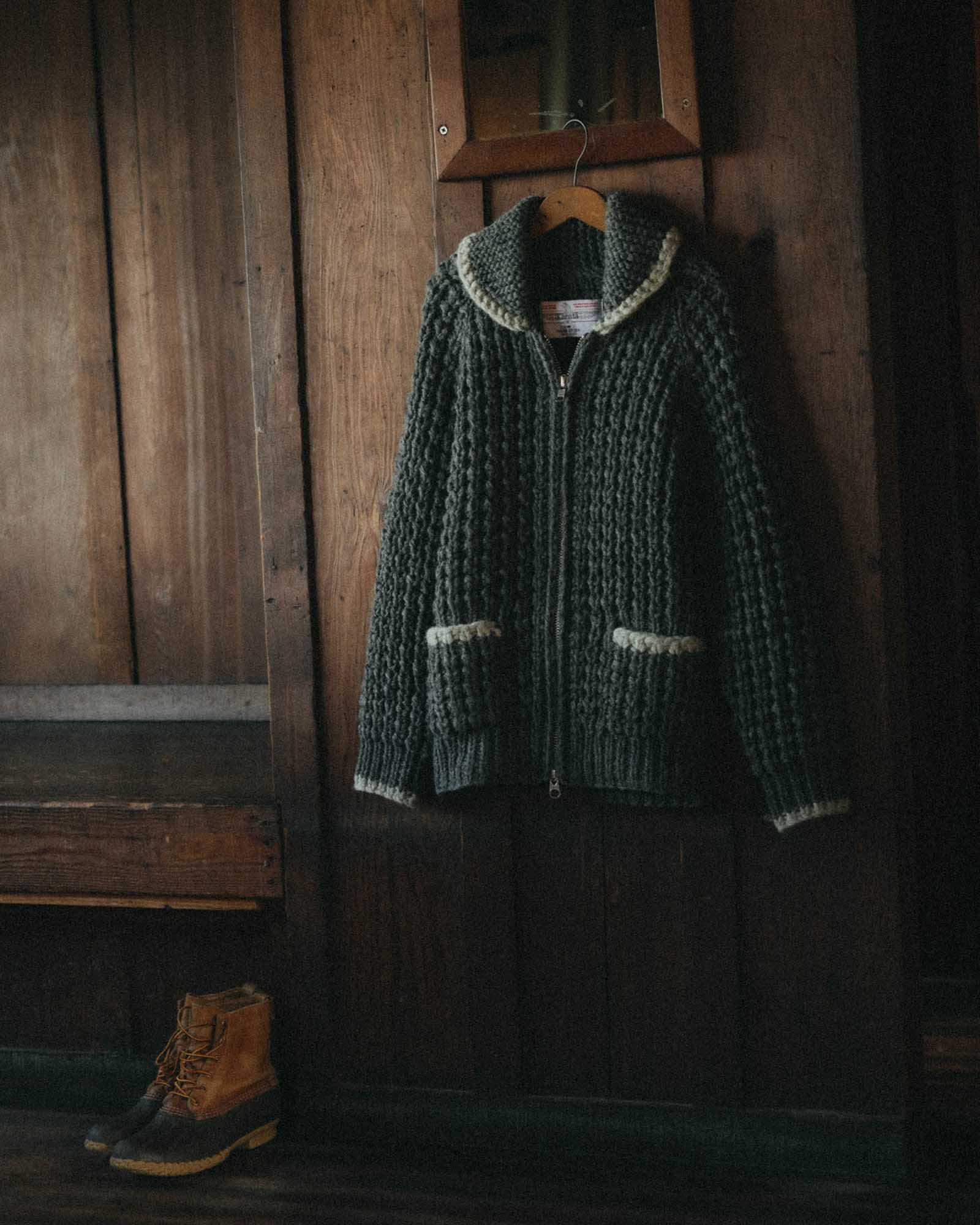 editorial image of The Seawall Hand-Knit Sweater in Heather Graphite hanging, Knits by Taylor Stitch