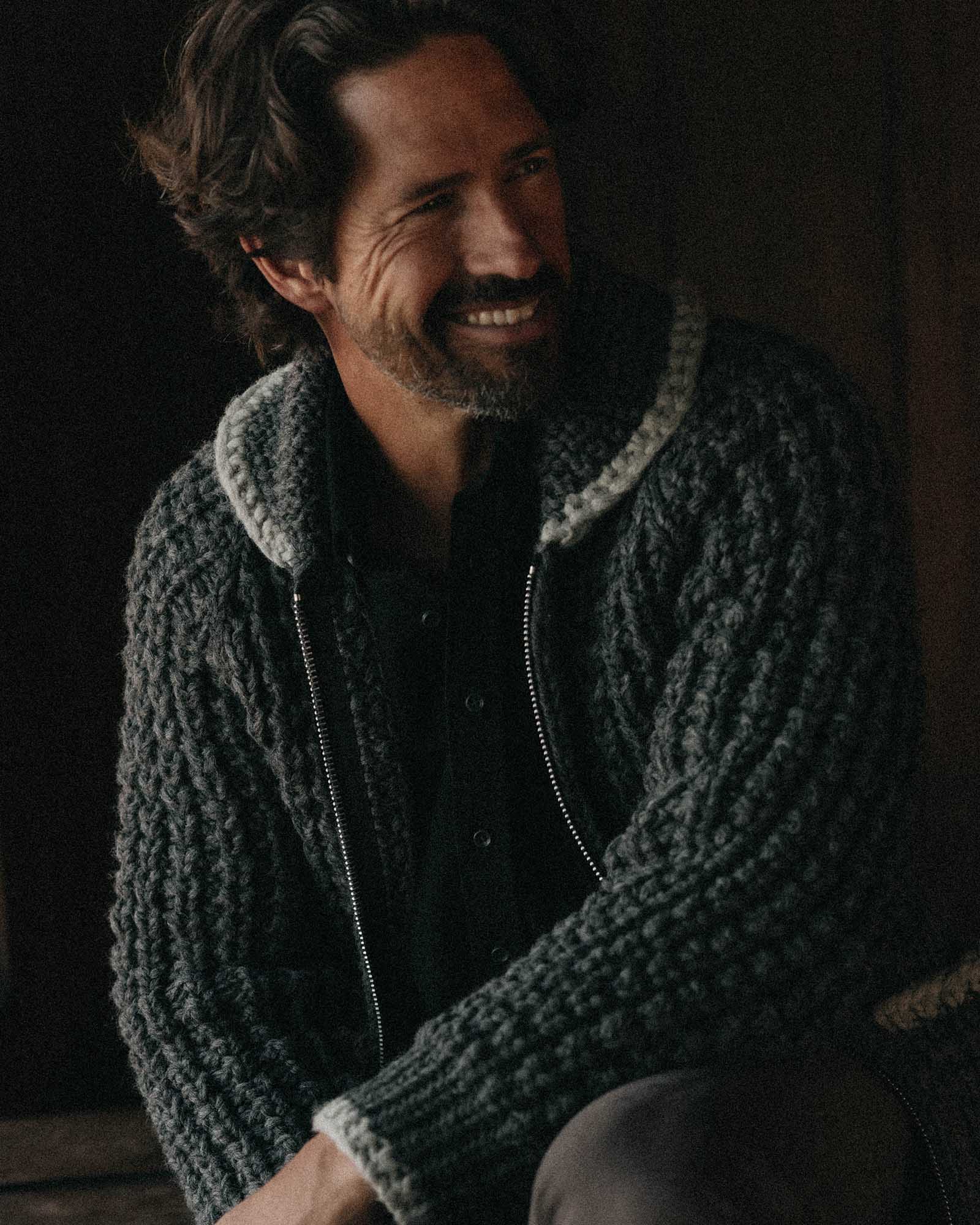 fit model sitting wearing The Seawall Hand-Knit Sweater in Heather Graphite, Knits by Taylor Stitch