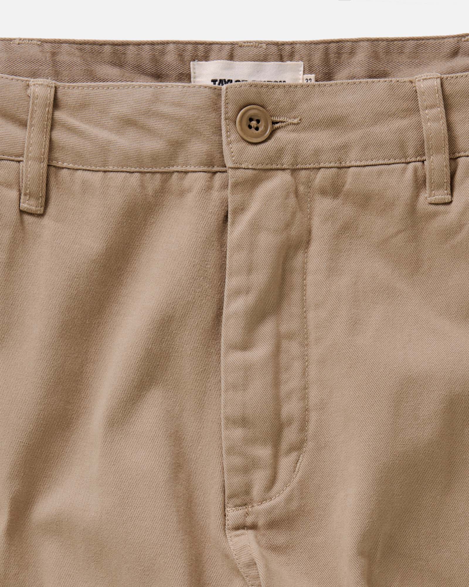 fit model standing wearing The Slim Foundation Pant in Organic Khaki, Bottoms by Taylor Stitch