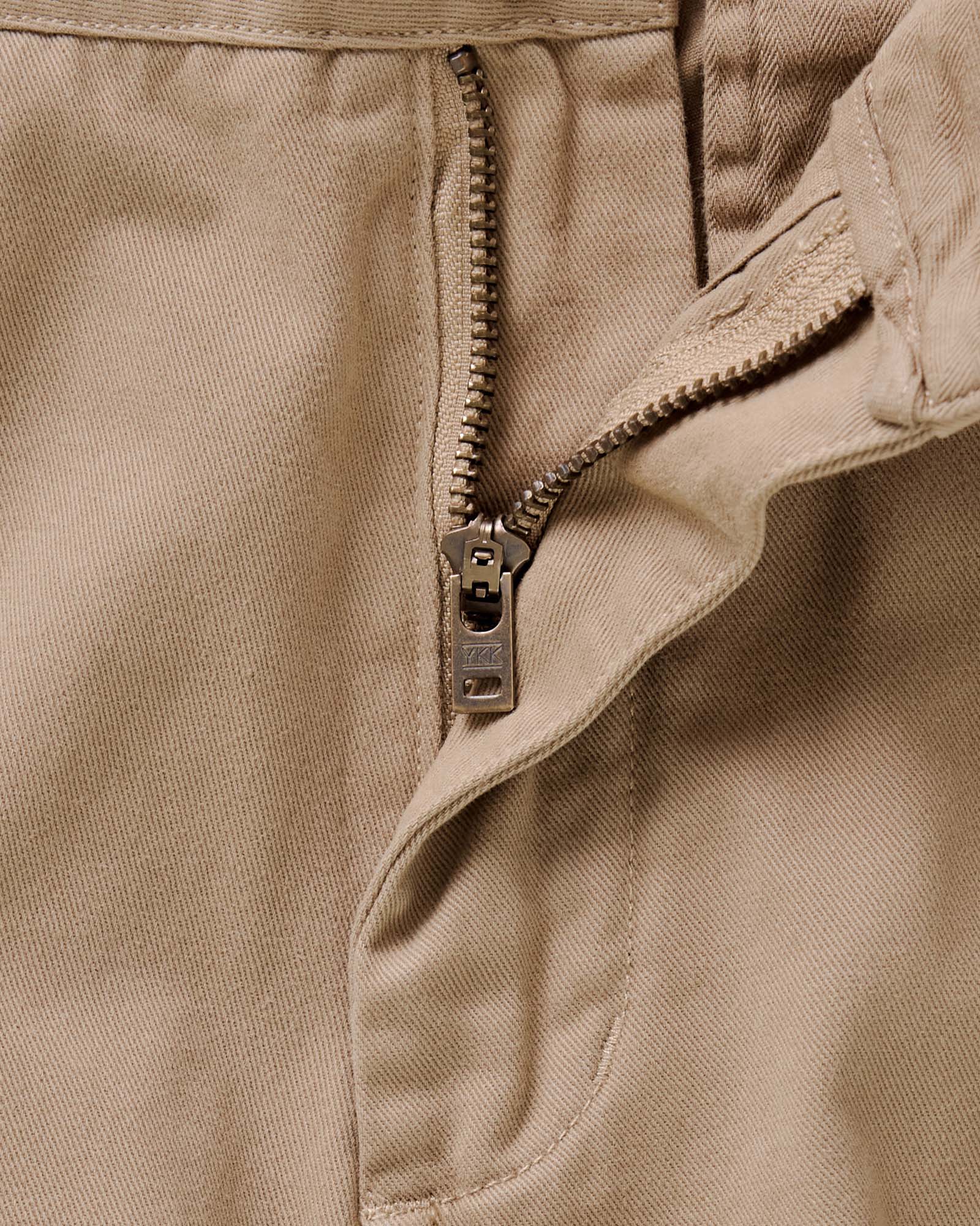 material shot of the zipper on The Slim Foundation Pant in Organic Khaki, Bottoms by Taylor Stitch