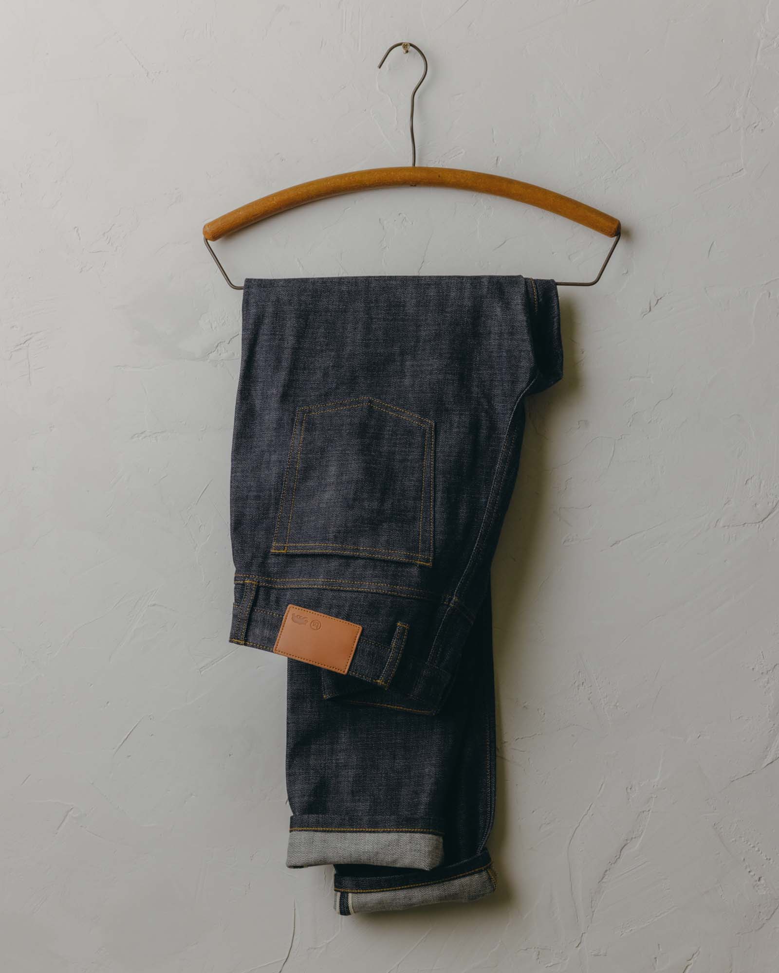 fit model posing in The Slim Jean in Rigid Organic Selvedge, Bottoms by Taylor Stitch