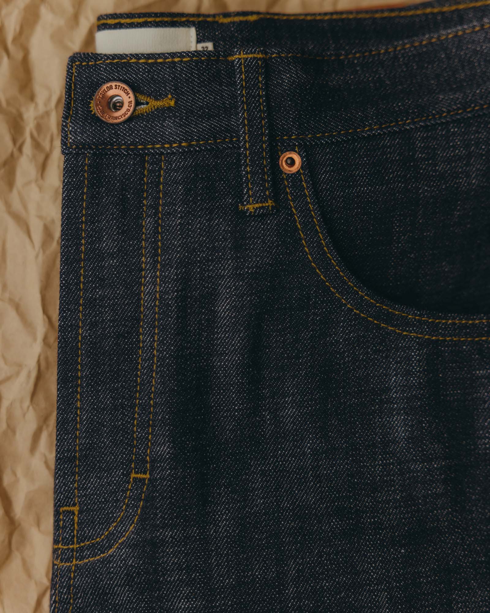 fit model showing off the back of The Slim Jean in Rigid Organic Selvedge, Bottoms by Taylor Stitch