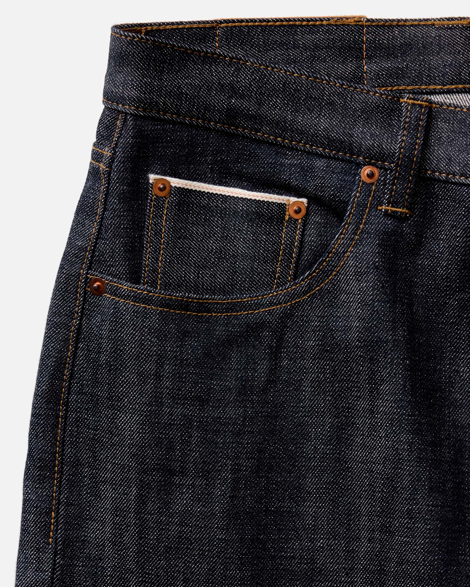 fit model with his hand in his pocket wearing The Slim Jean in Rigid Organic Selvedge, Bottoms by Taylor Stitch