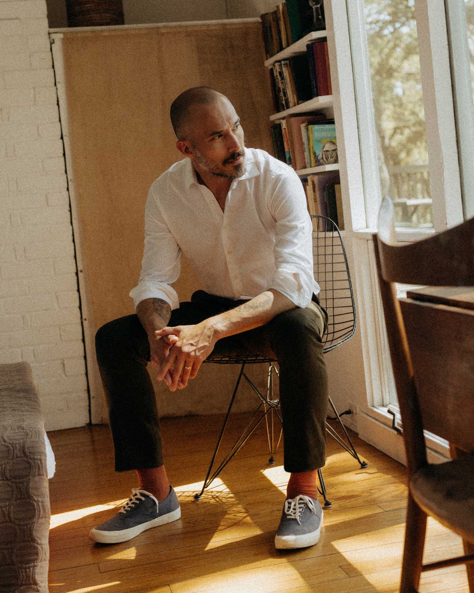 fit model sitting wearing The Stevens Trouser in Black Olive Wool Flannel, Bottoms by Taylor Stitch