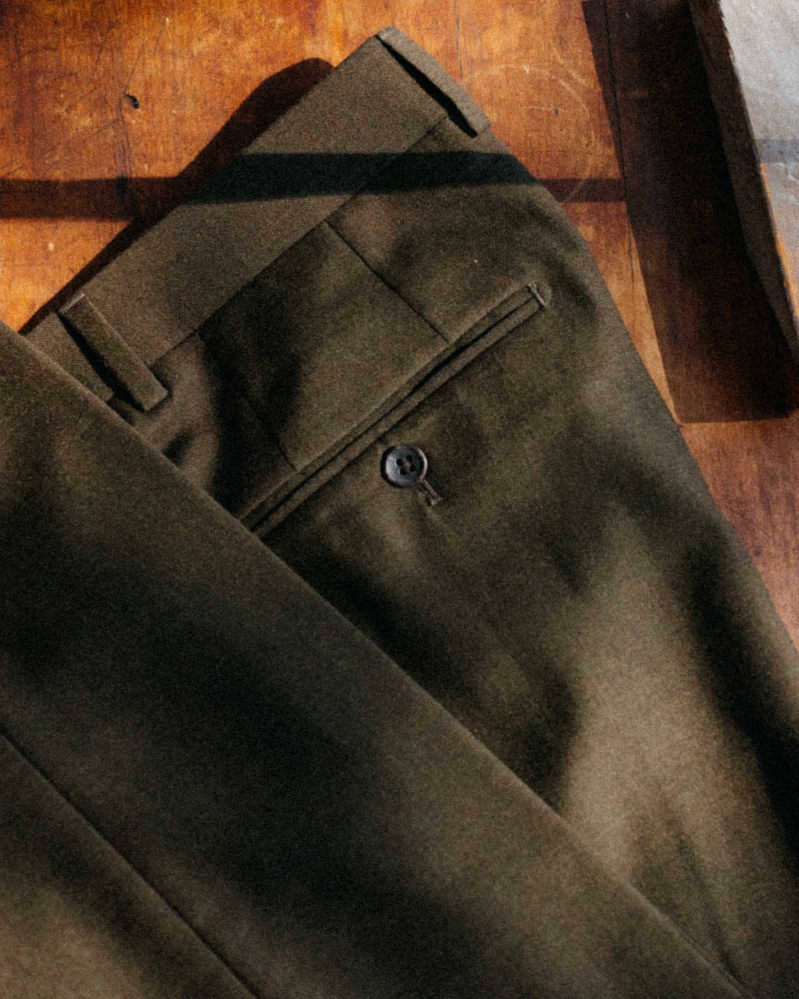editorial flatlay of The Stevens Trouser in Black Olive Wool Flannel, Bottoms by Taylor Stitch