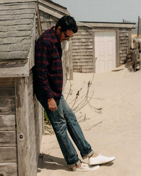 fit model leaning against a wall wearing The Yosemite Shirt in Port Plaid, Wovens by Taylor Stitch