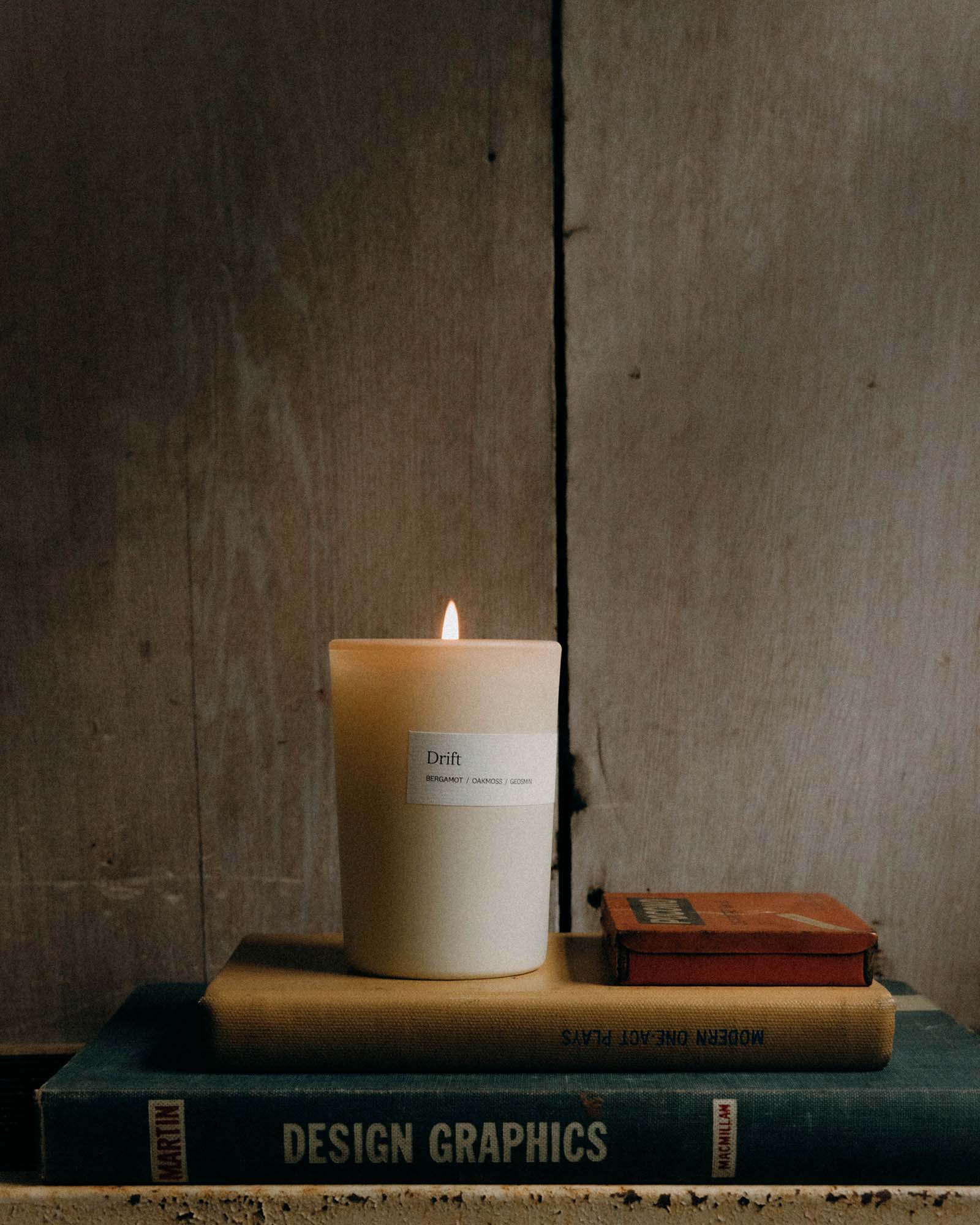 editorial image of The Candle in Drift on books, Accessories by Taylor Stitch