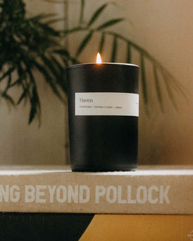 editorial image of The Candle in Haven on a book, Accessories by Taylor Stitch