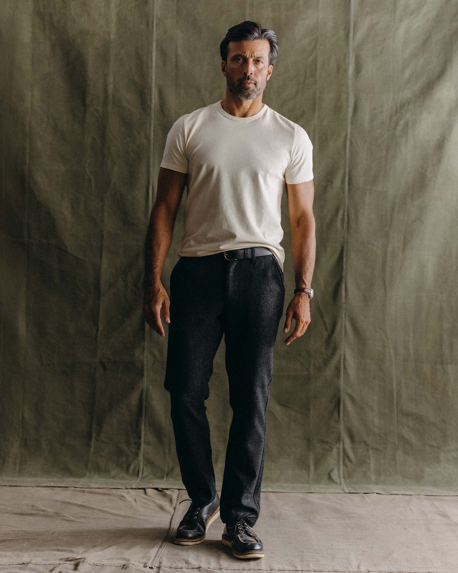 fit model leaning against the wall wearing The Carnegie Pant in Heather Charcoal Wool, Bottoms by Taylor Stitch