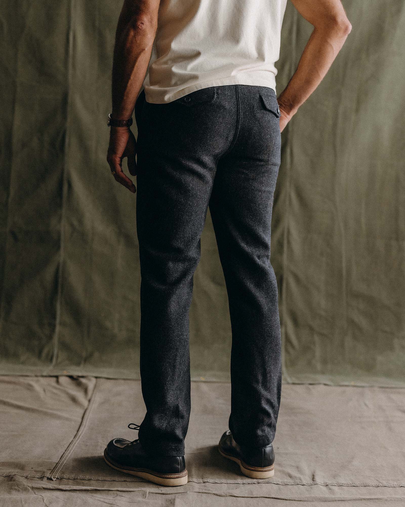fit model with his hand in his pocket wearing The Carnegie Pant in Heather Charcoal Wool, Bottoms by Taylor Stitch