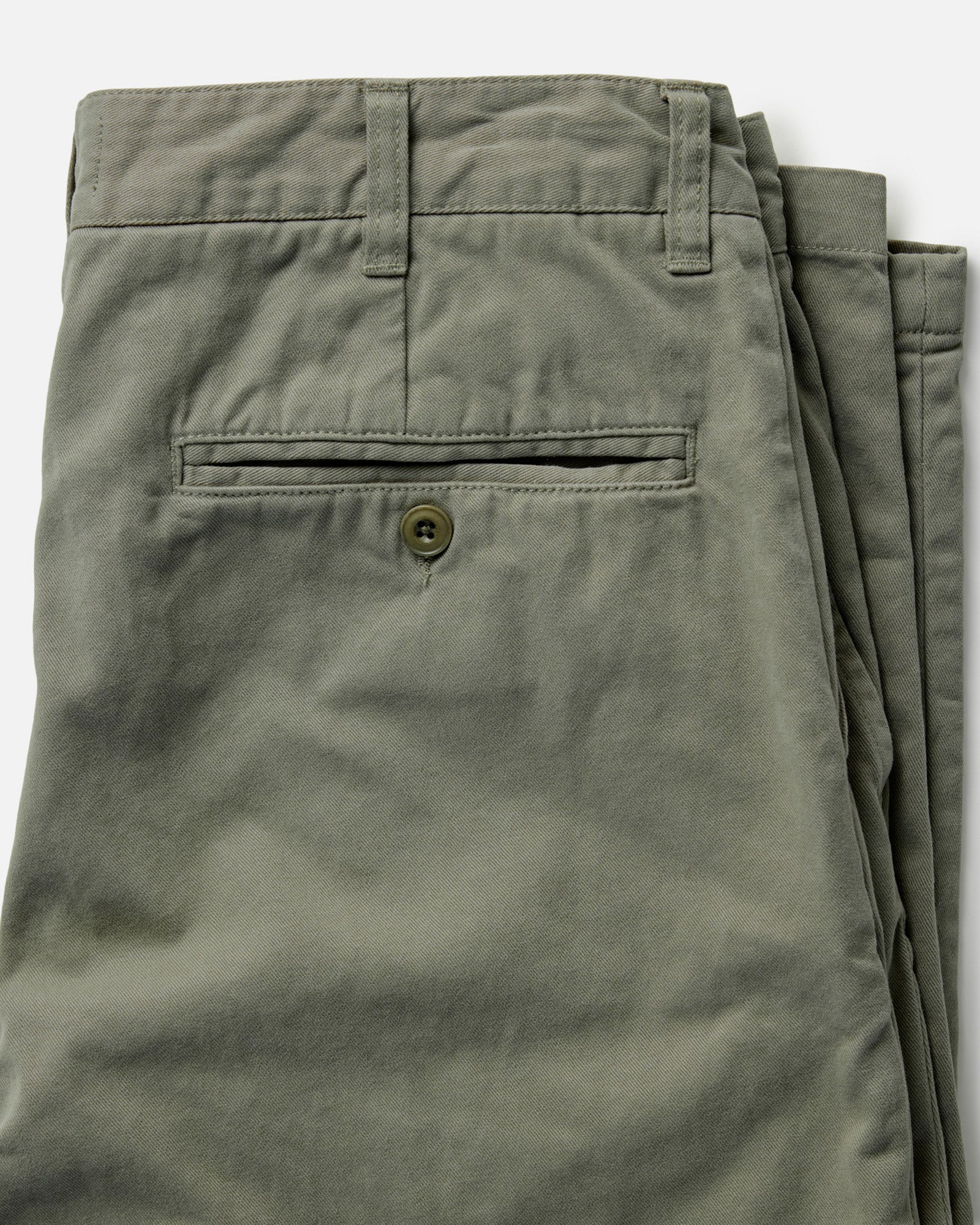 material shot of the back button-through pocket on The Democratic Foundation Pant in Organic Smoked Olive, Bottoms by Taylor Stitch