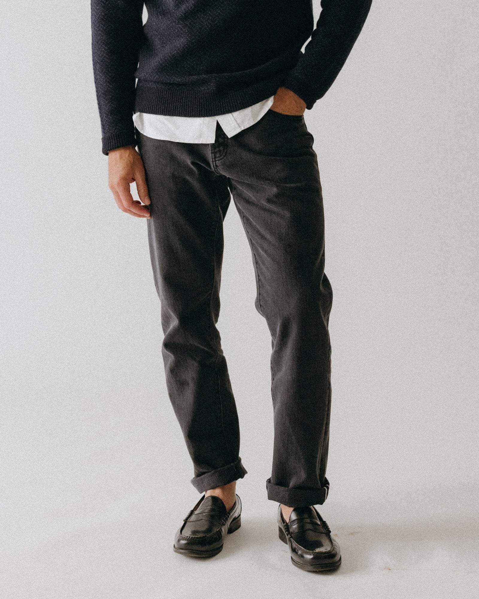 fit model posing in The Democratic Jean in Washed Black Organic Slub Selvedge, Bottoms by Taylor Stitch