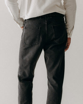 fit model showing off the back pocket on The Democratic Jean in Washed Black Organic Slub Selvedge, Bottoms by Taylor Stitch