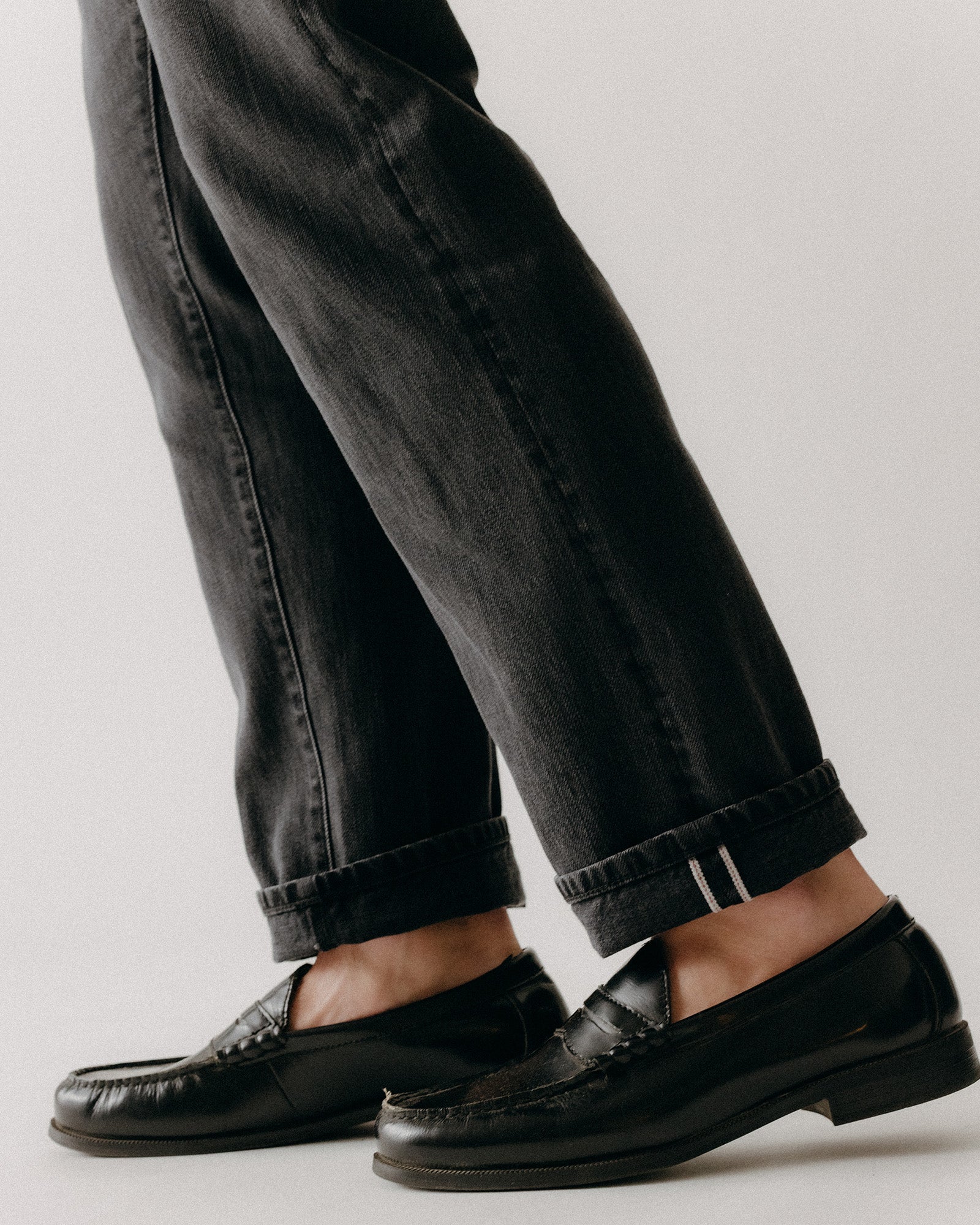 fit model showing off the cuffs on The Democratic Jean in Washed Black Organic Slub Selvedge, Bottoms by Taylor Stitch