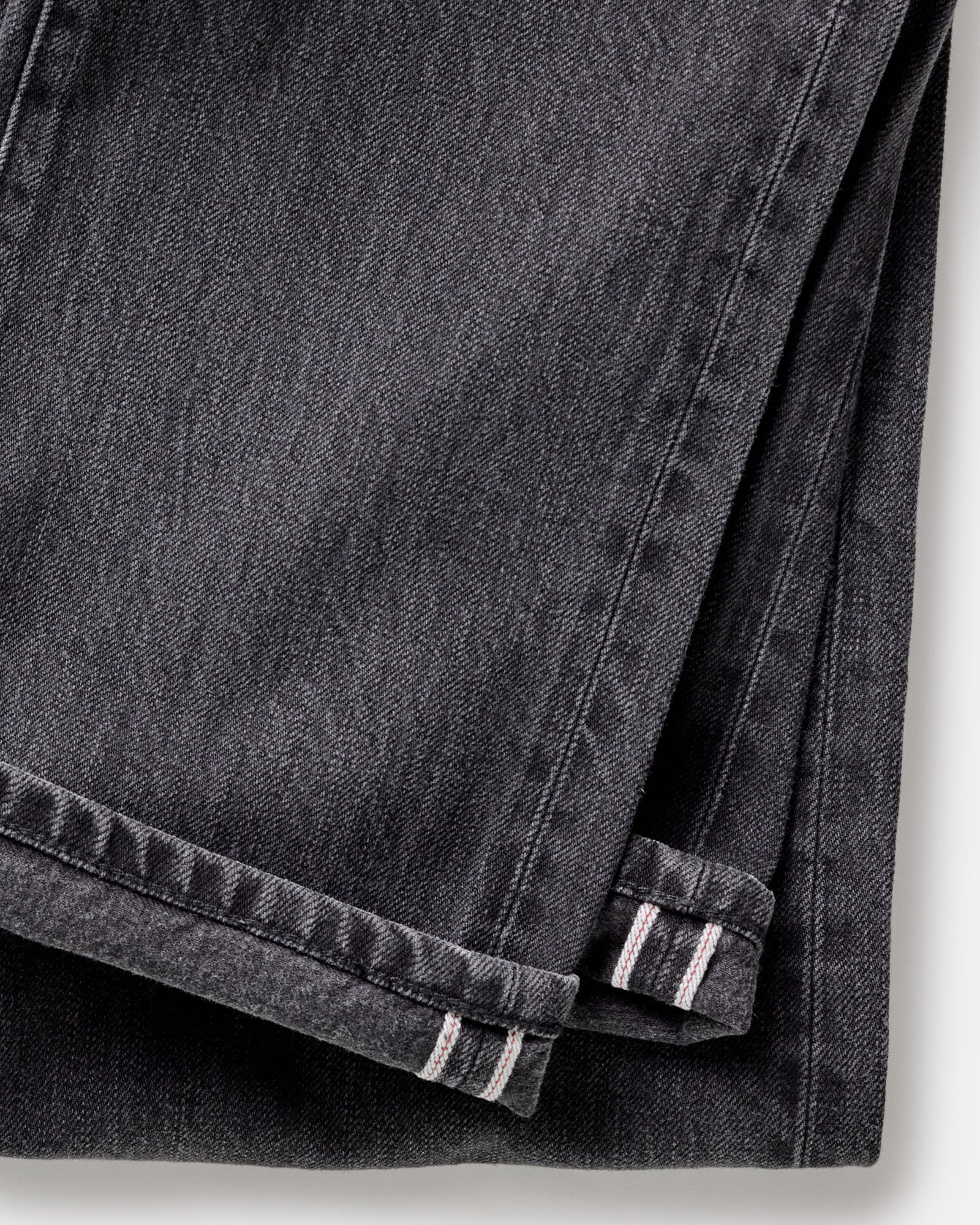 material shot of the selvedge cuffs on The Democratic Jean in Washed Black Organic Slub Selvedge, Bottoms by Taylor Stitch