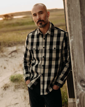 fit model posing in The Division Shirt in Black Indigo Check, Wovens by Taylor Stitch