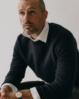 fit model sitting wearing The Eddy Crew in Heather Marine Herringbone, Knits by Taylor Stitch