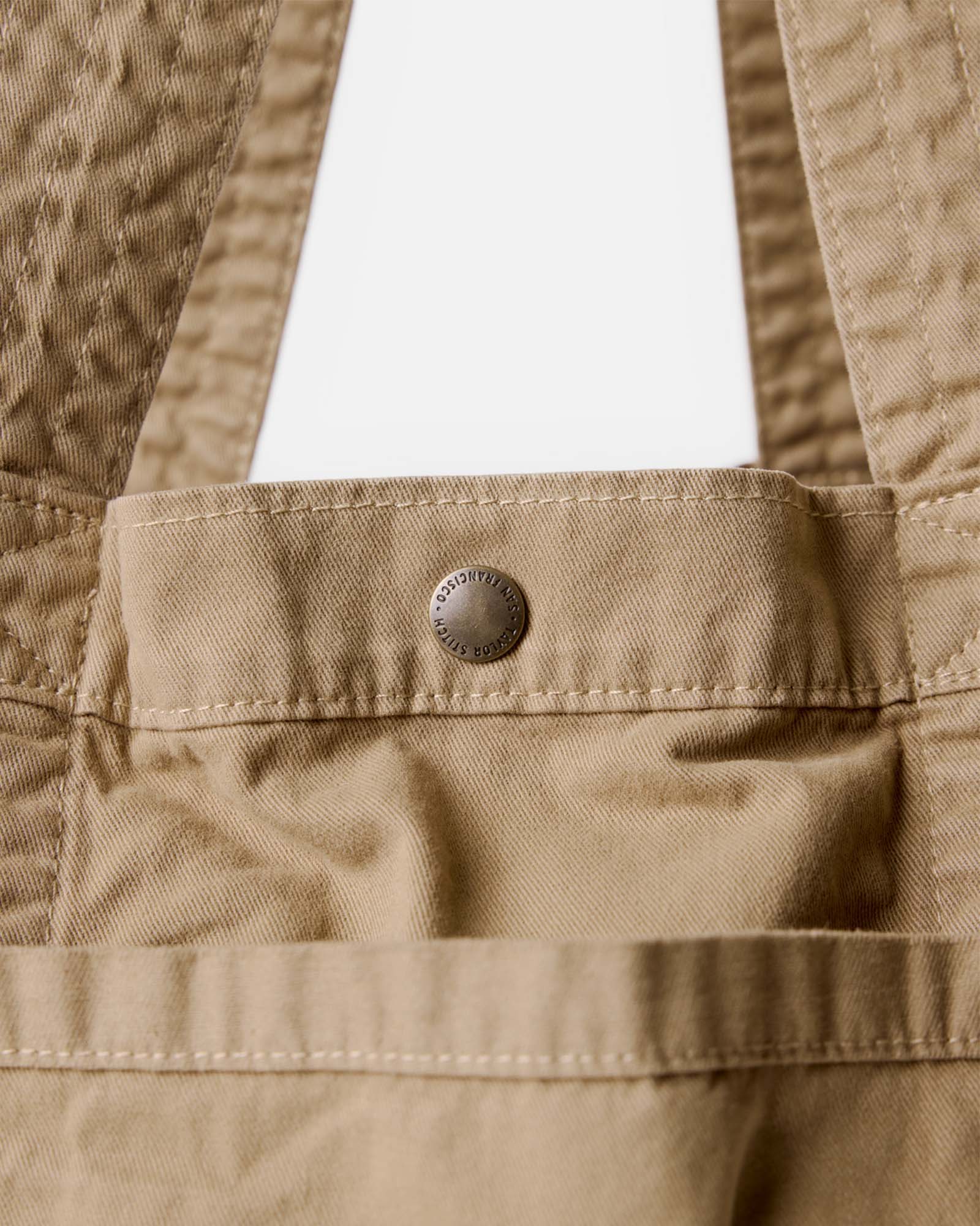 material shot of the button on The Foundation Tote in Organic Khaki, Accessories by Taylor Stitch