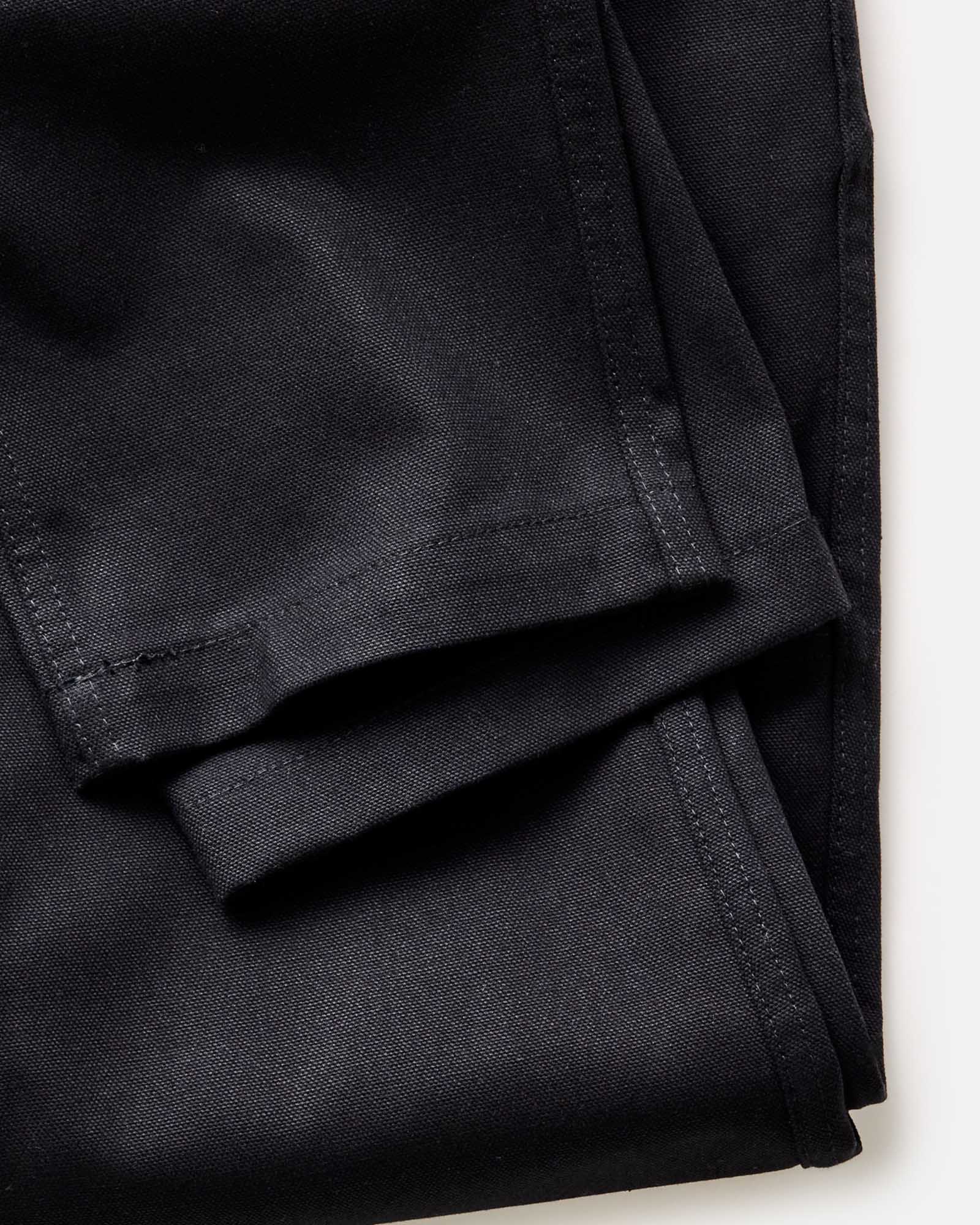 material shot of the hem on The Good Acre Chore Pant in Black Canvas, Bottoms by Taylor Stitch