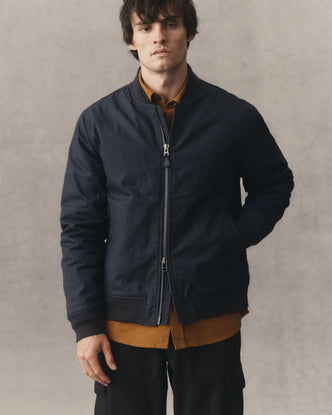fit model posing in The Insulated Bomber Jacket in Dark Navy Dry Wax