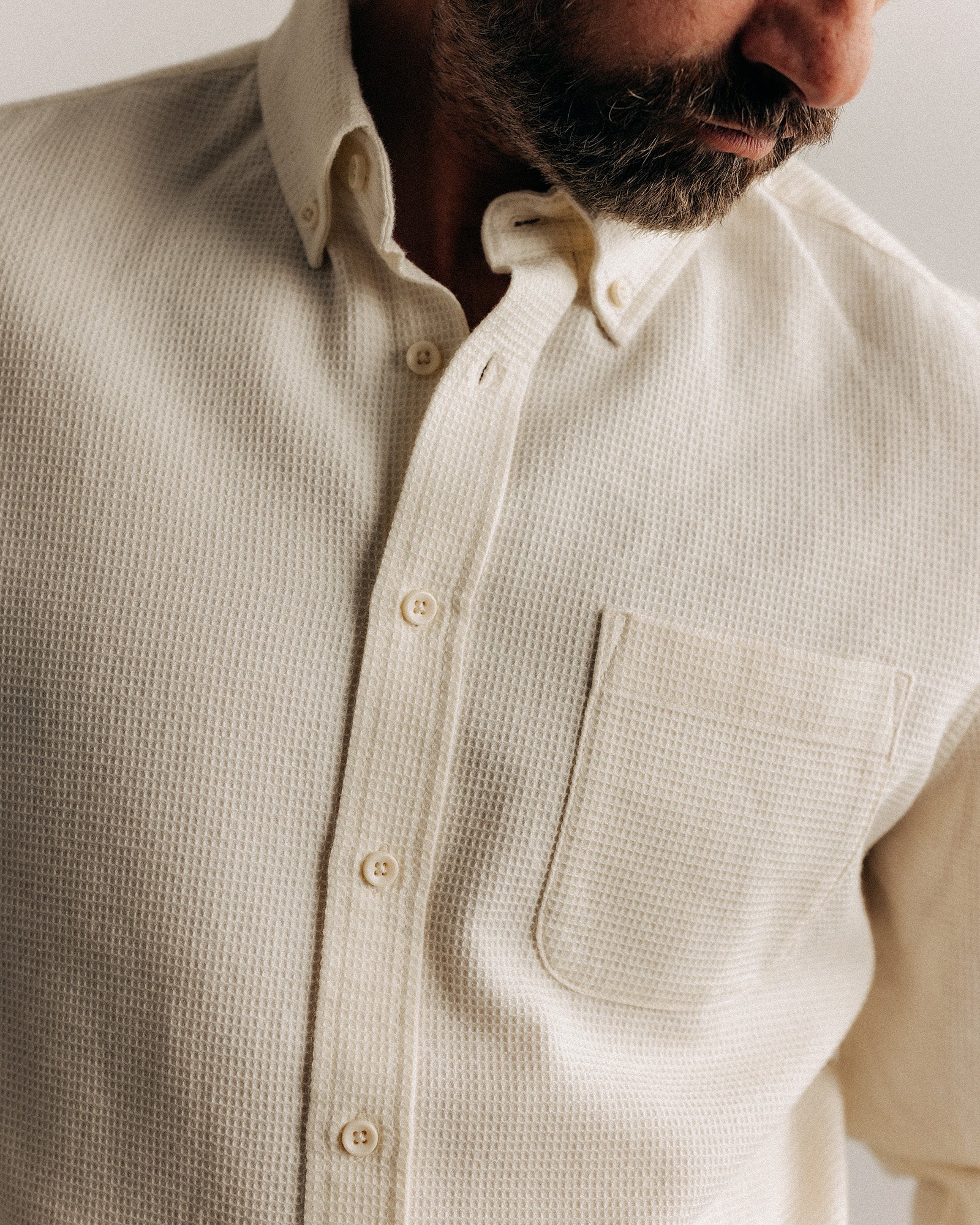 fit model showing off the buttons on The Jack in Vintage White Waffle, Wovens by Taylor Stitch