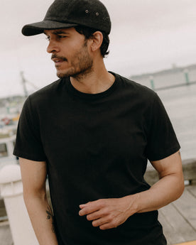 fit model posing in The Organic Cotton Tee in Black, Knits by Taylor Stitch