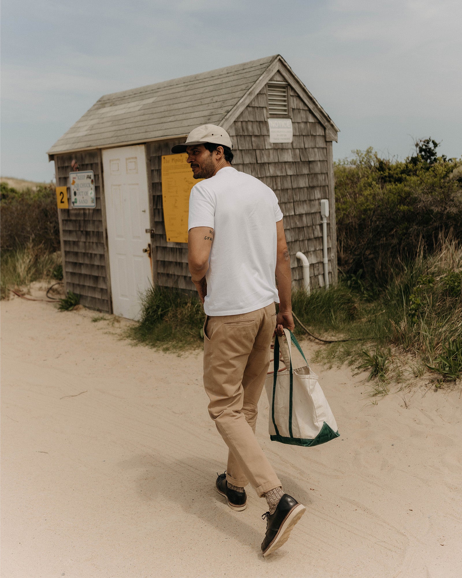 fit model walking wearing The Organic Cotton Tee in White, Knits by Taylor Stitch