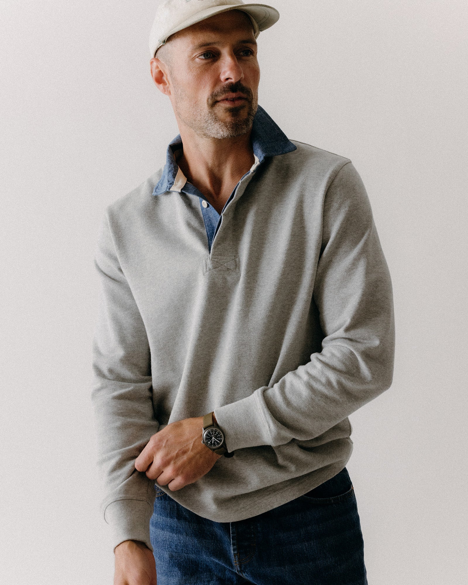fit model adjusting the cuffs on The Rugby Shirt in Heather Grey, Knits by Taylor Stitch
