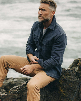 fit model adjusting the sleeves on The Shop Shirt in Navy Chipped Canvas, Wovens by Taylor Stitch