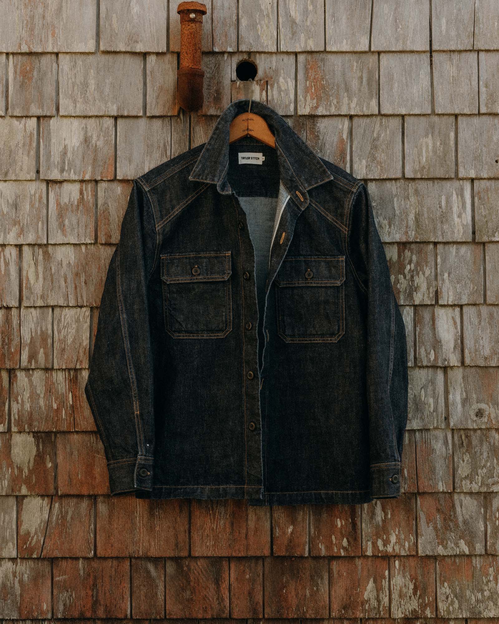 editorial image of The Shop Shirt in Rinsed Indigo Selvedge hanging, Wovens by Taylor Stitch