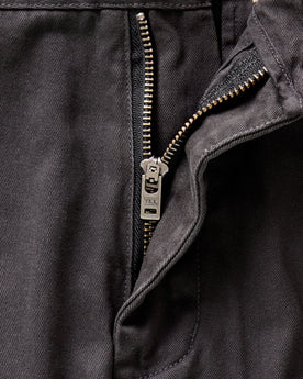 material shot of the YKK zipper fly on The Slim Foundation Pant in Organic Faded Black, Bottoms by Taylor Stitch