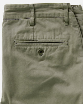 material shot of the back button through pocket on The Slim Foundation Pant in Organic Smoked Olive, Bottoms by Taylor Stitch